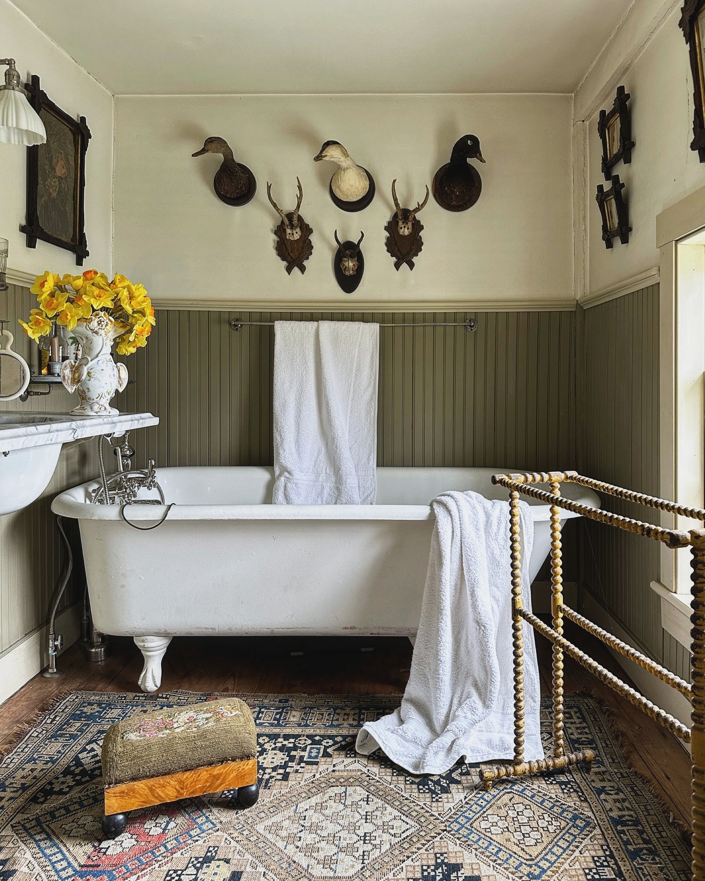 11. Vintage Clawfoot Tub with Checkerboard Floor and Brass Fixtures
