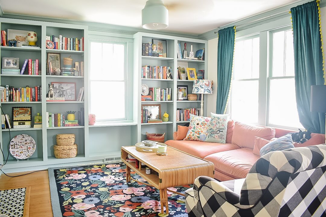 12. Cascading Book Avalanche with Rustic Ladder on Whitewashed Wall