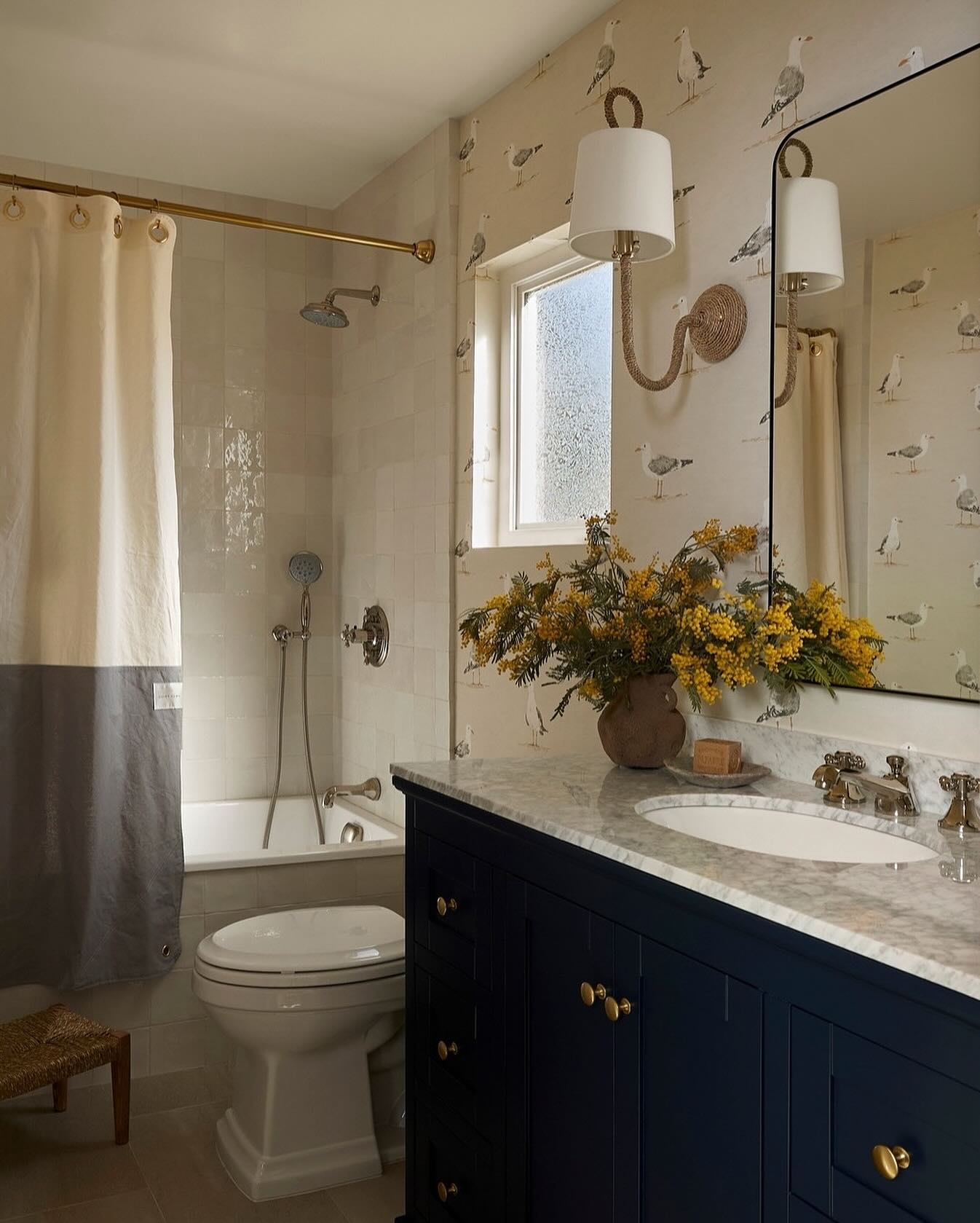 5. Coastal Serenity: Driftwood Mirror and Woven Basket Accents In a Crisp White Bathroom