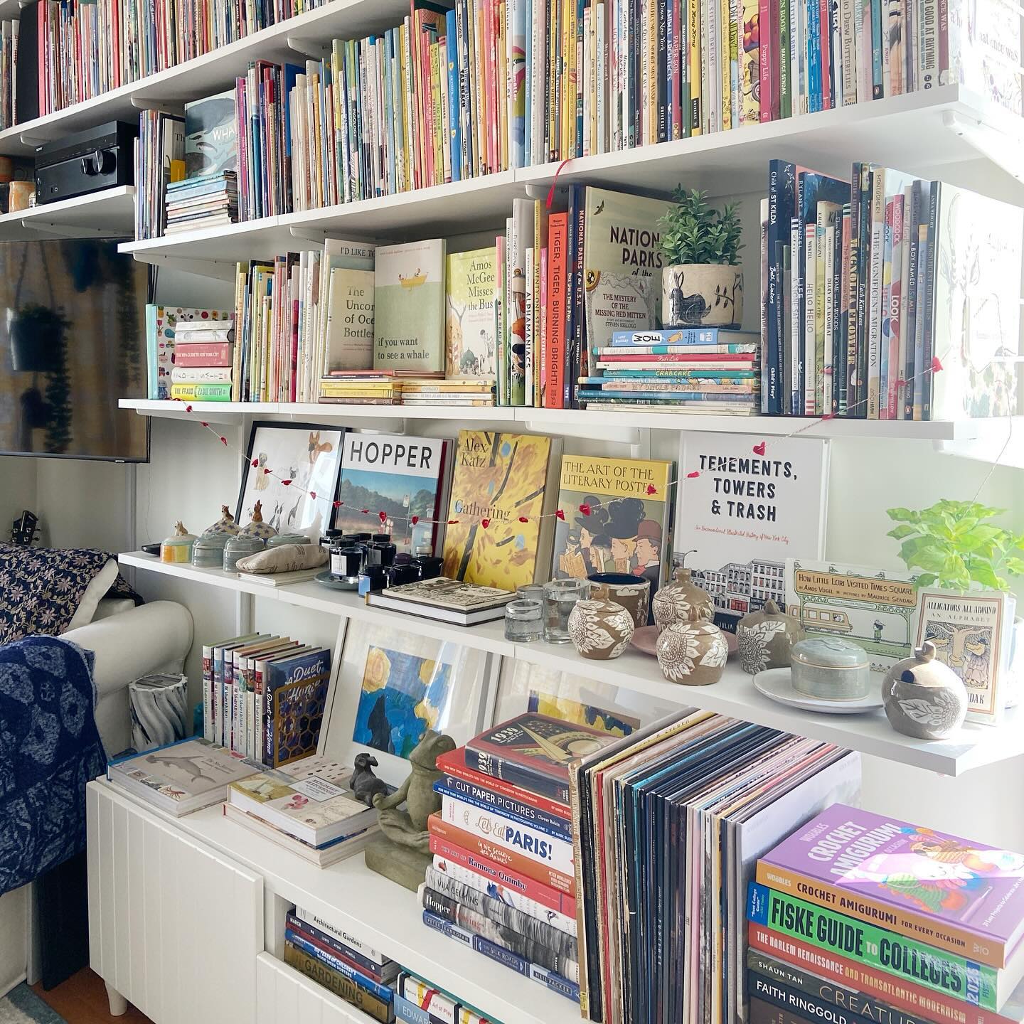 22. Cascading Books and Geometric Vases on a Two-toned Shelf