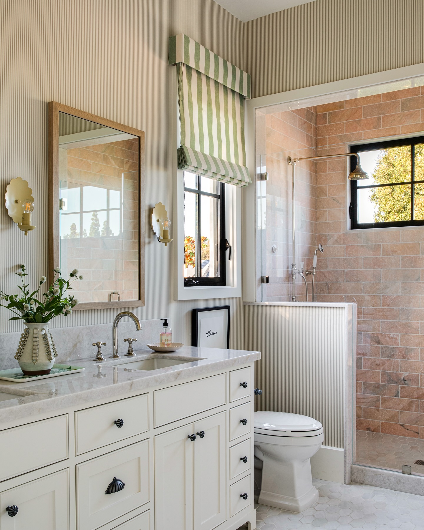 7. Metallic Gold Accents Meet Vintage Charm In a Petite Powder Room