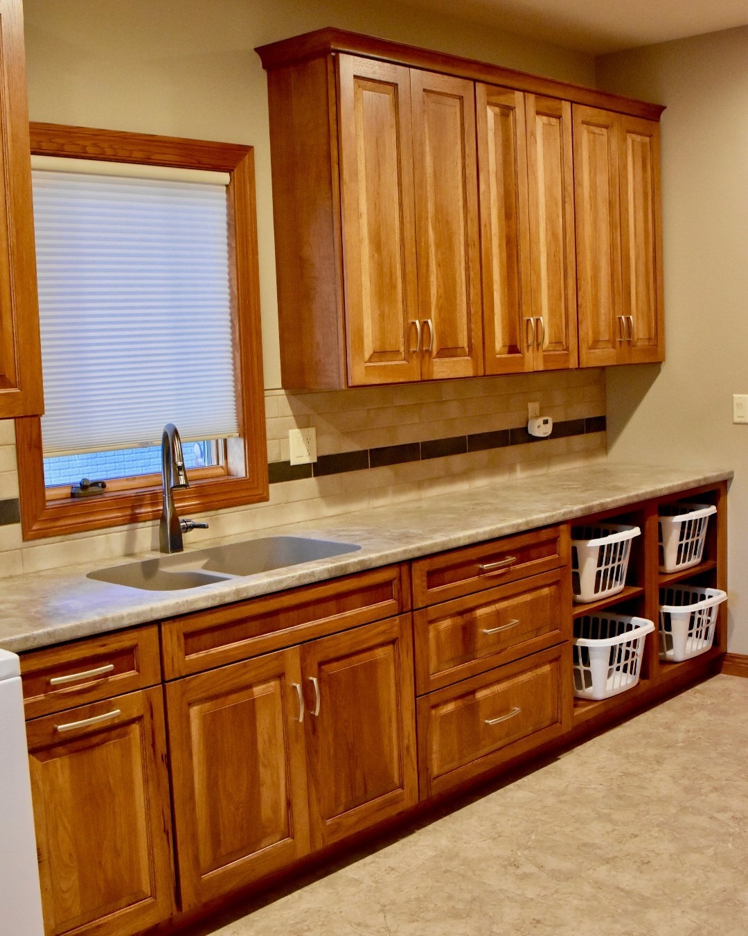 6. Sleek White Cabinets with Industrial Black Handles and Perforated Metal Doors