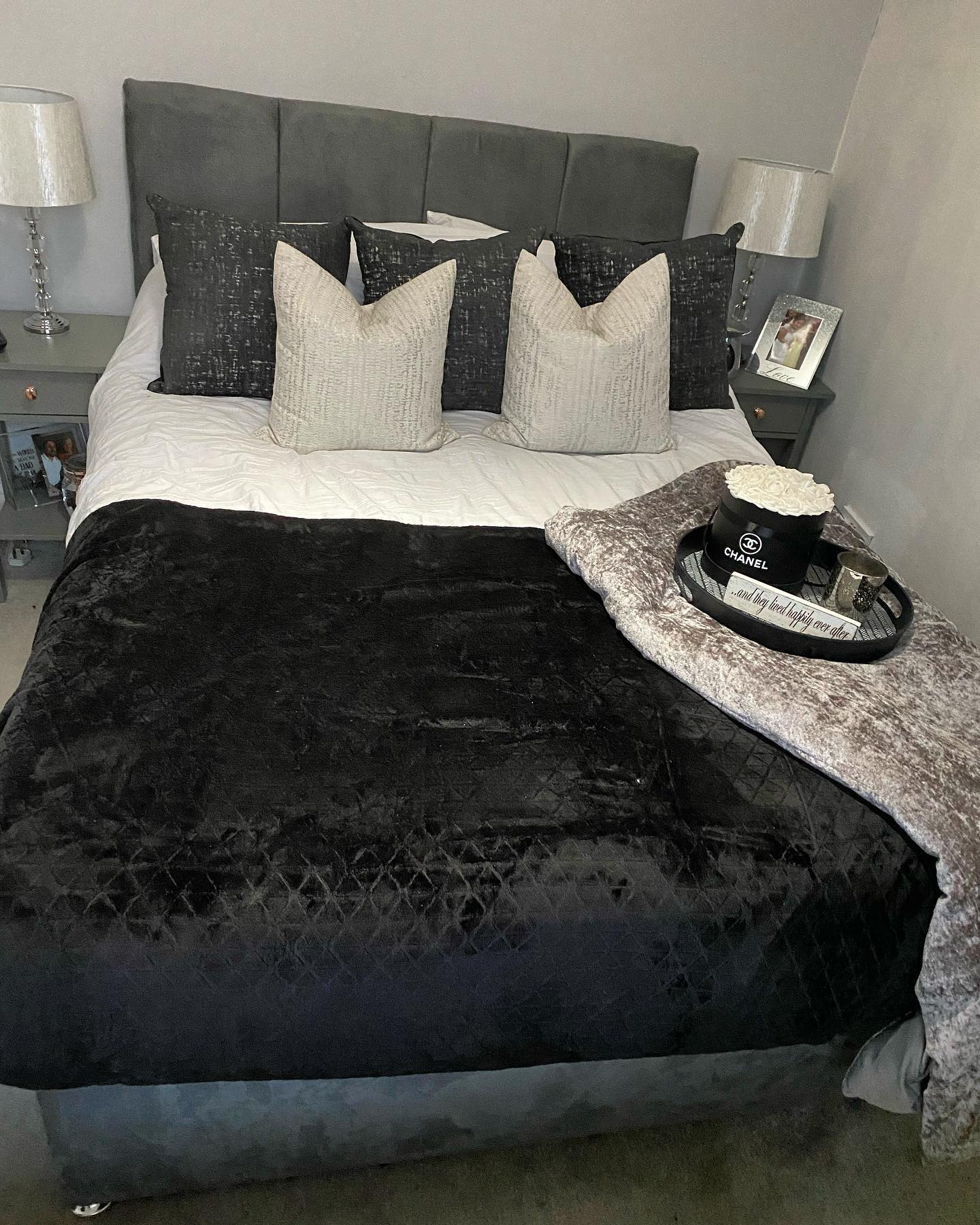10. Monochromatic Haven with Geometric Wall Art and Vintage Bed Frame