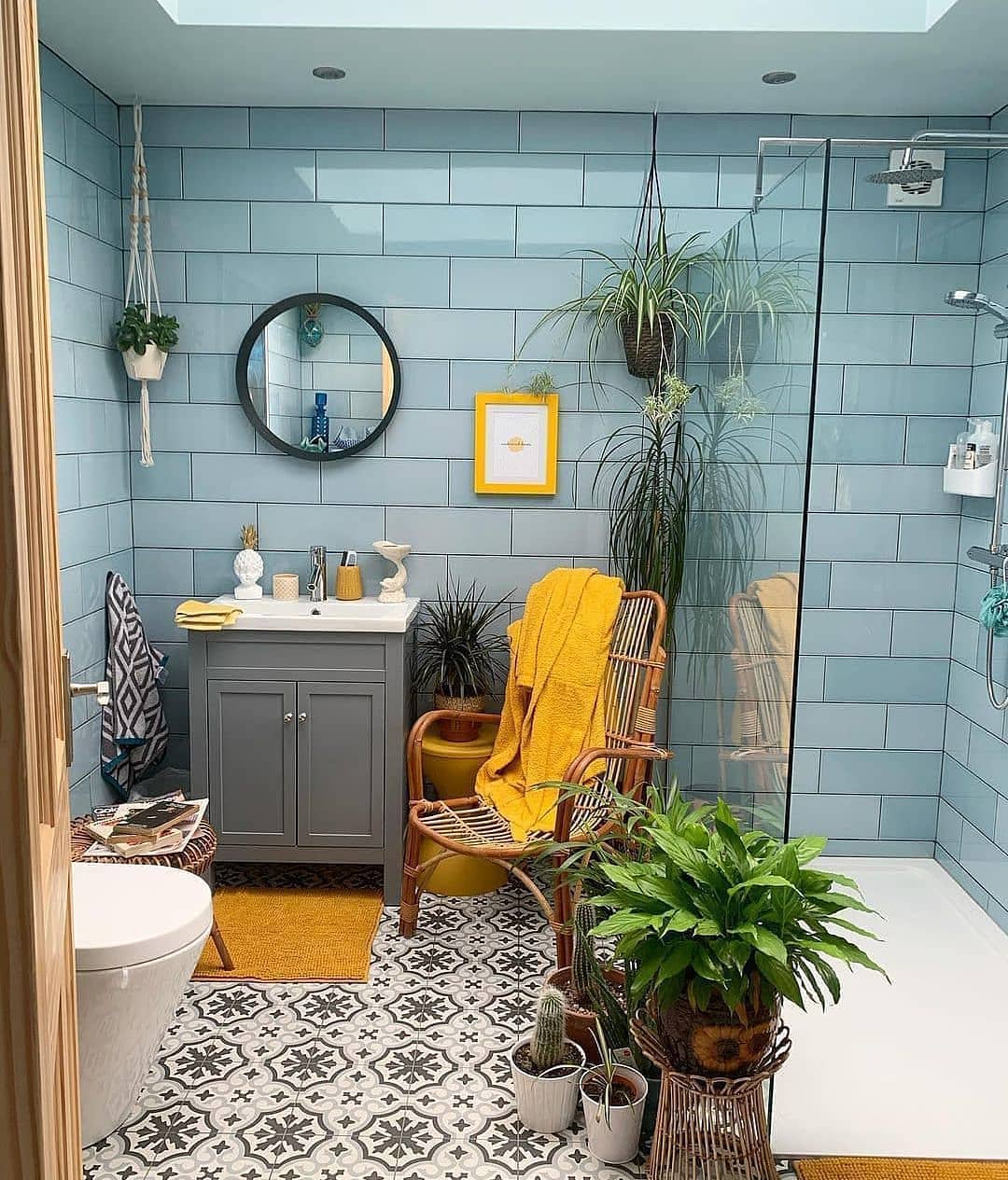 25. Vibrant Tangerine Walls with Geometric White Tile Accents and a Sleek Black Fixture