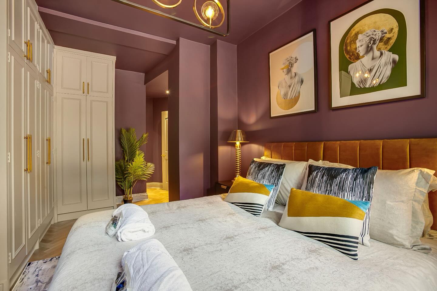 7. Soft Mauve Canopy Over Vintage Brass Bed with Patterned Throw