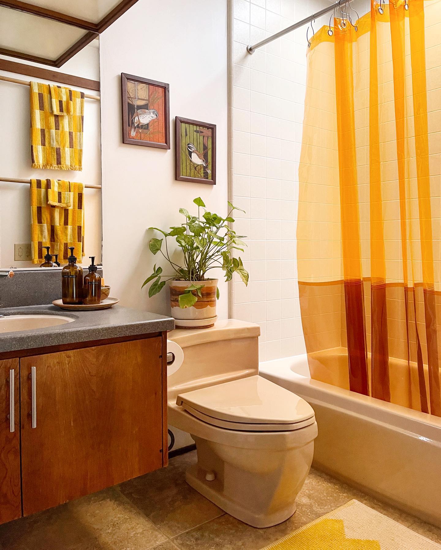 2. Vibrant Fuchsia Vanity Against Geometric Green Tiles In a Compact Urban Bathroom
