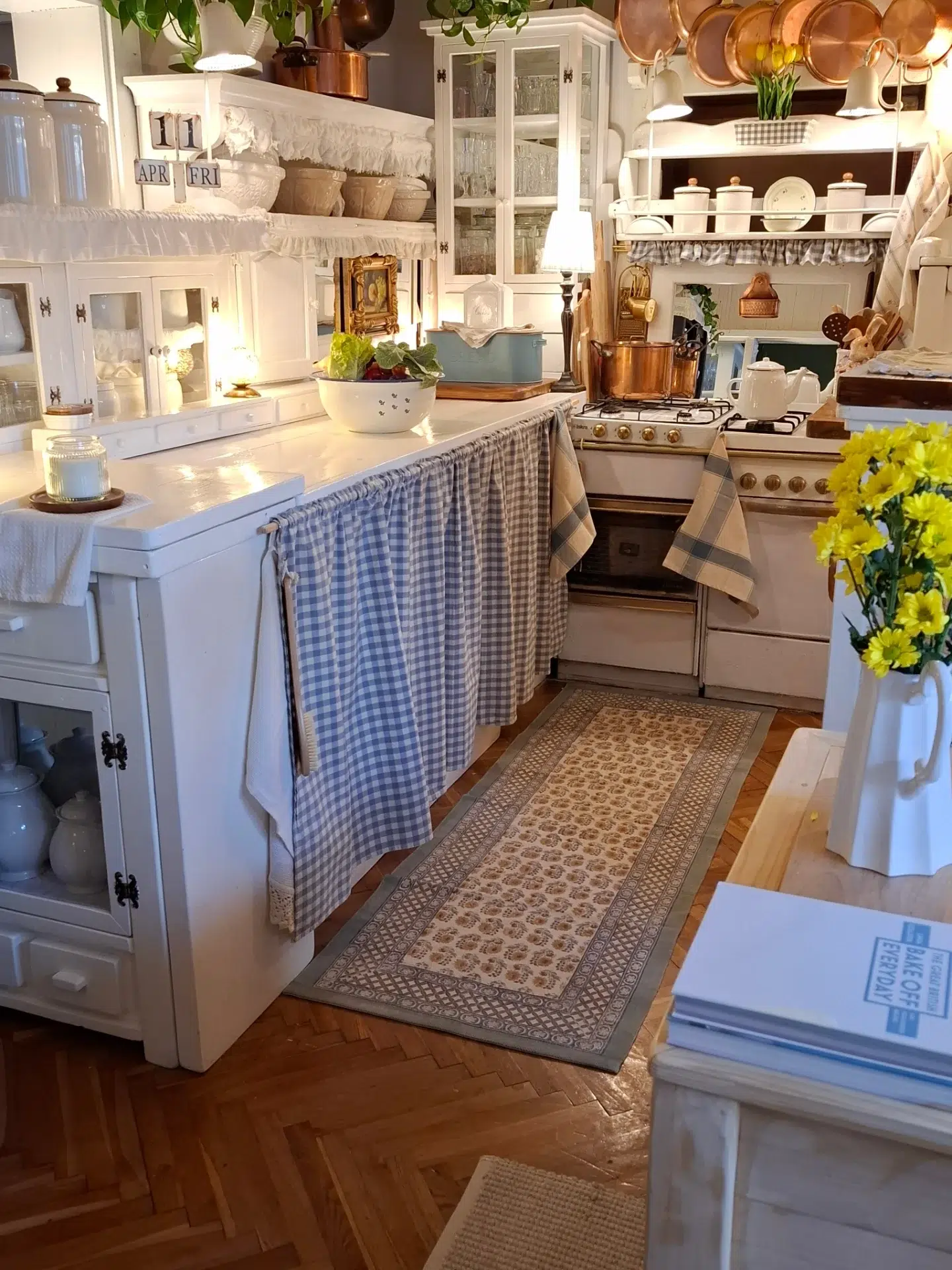 9. Sunlit Sage Green Cabinets with Vintage Copper Accents and Distressed Wood Shelving