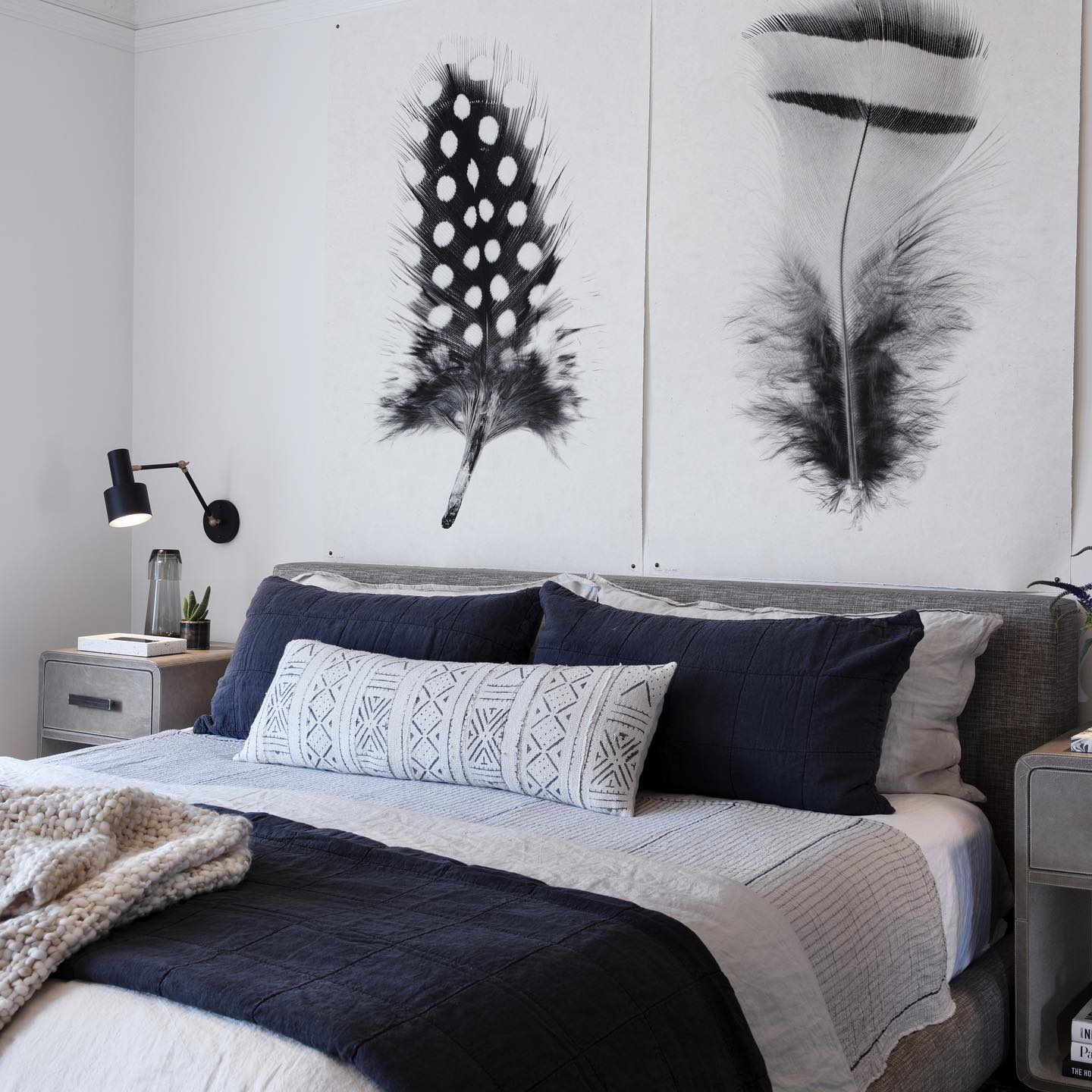 7. Midnight Moonlight Elegance: a Black and White Bedroom with a Crescent Moon Wall Art