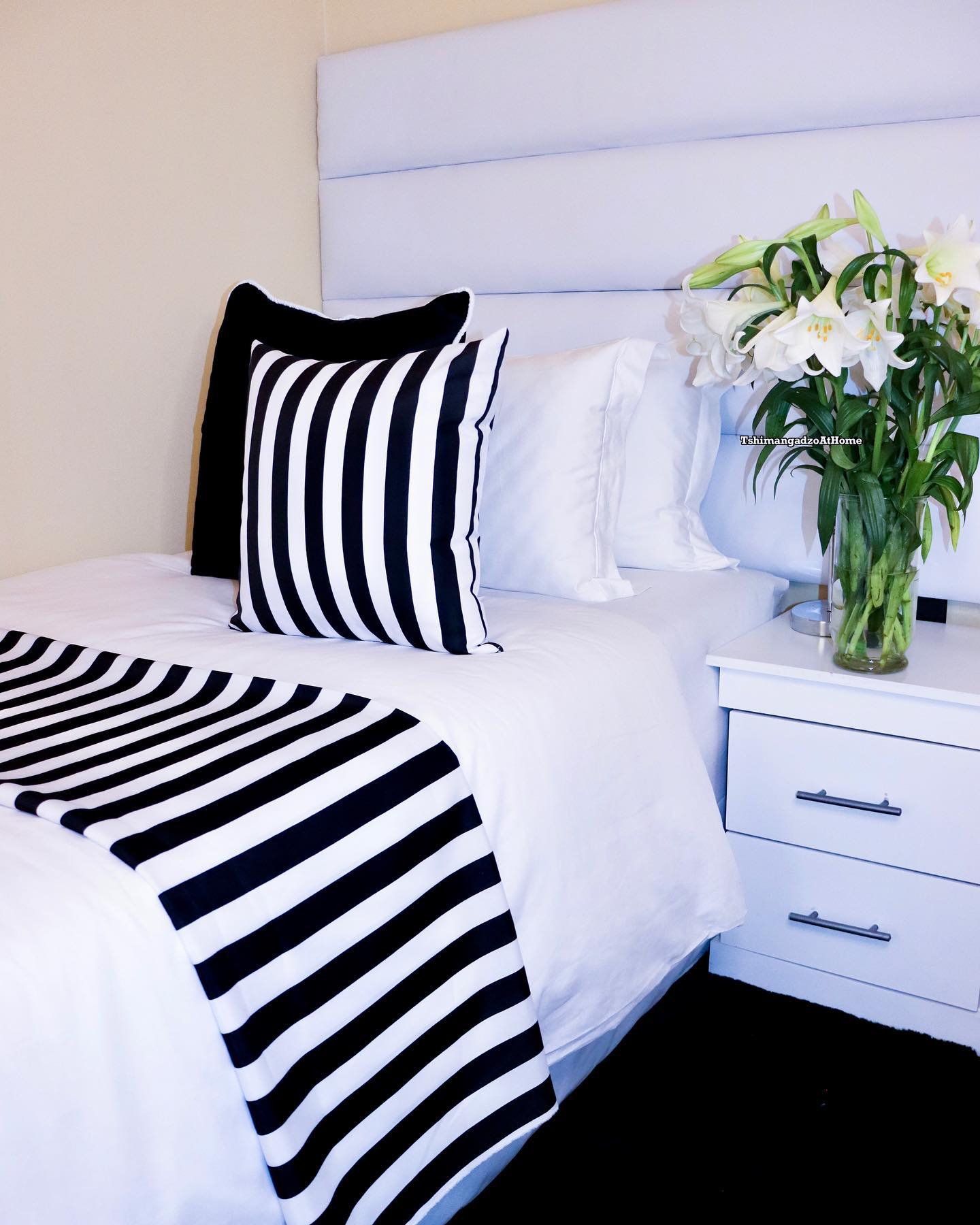 6. Monochromatic Moonlit Waves: a Bedside Table with a Sculptural Lamp and Vintage Alarm Clock