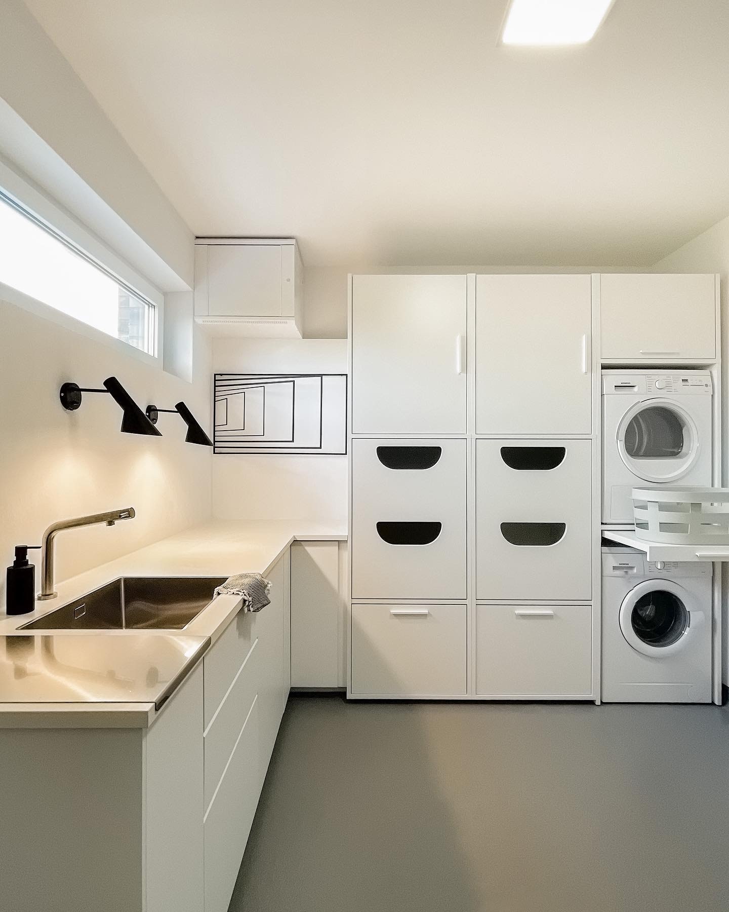 9. Cascading Wicker Baskets and Sliding Barn Door In a Compact Laundry Space