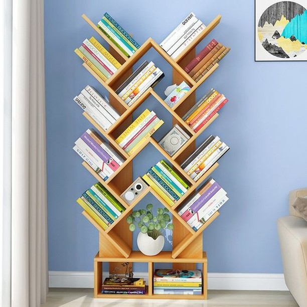 4. Floating Shelves with Geometric Book Arrangement and Greenery Accents